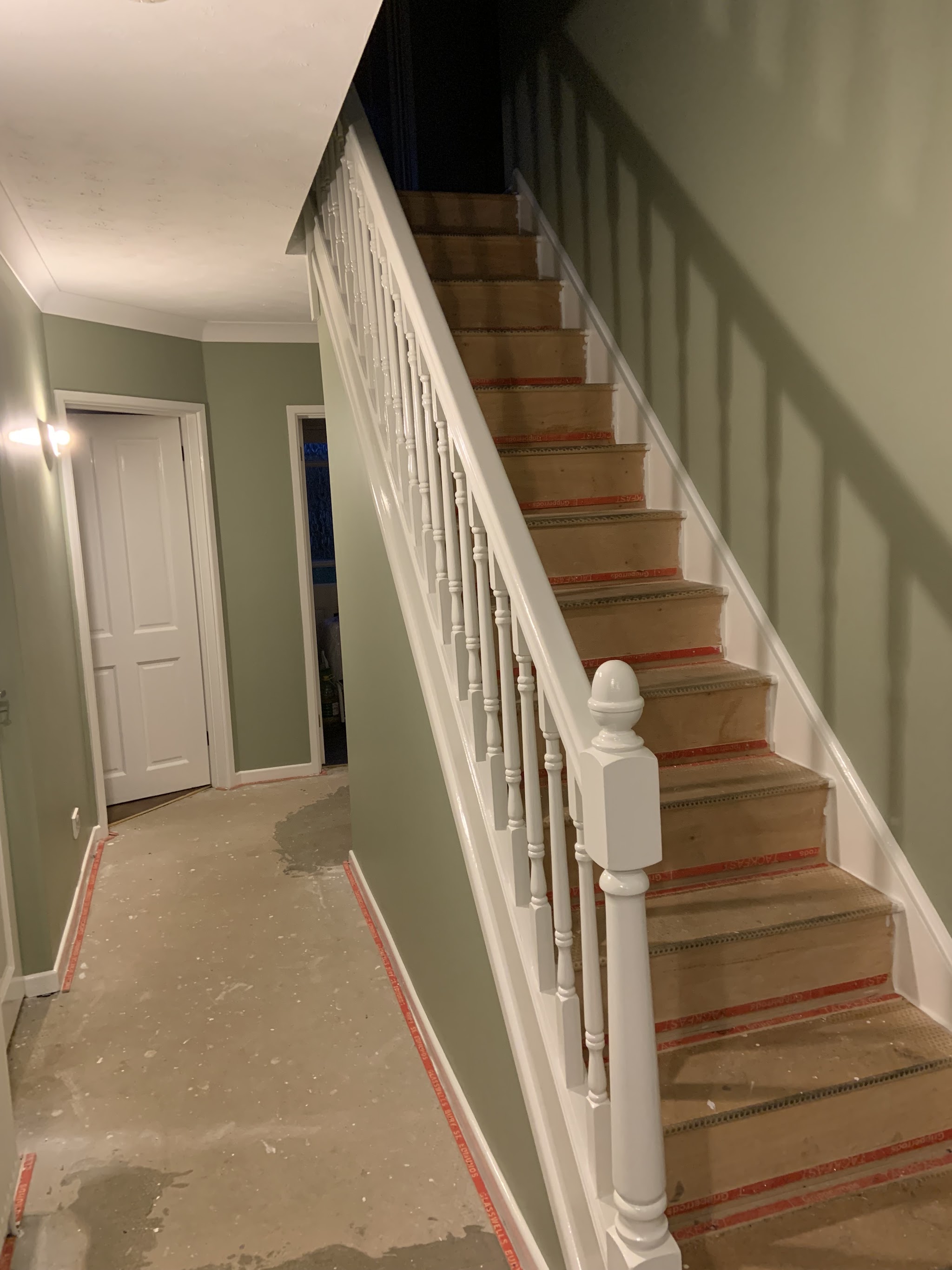 Hallway and stairs part way through decorating, floor protected