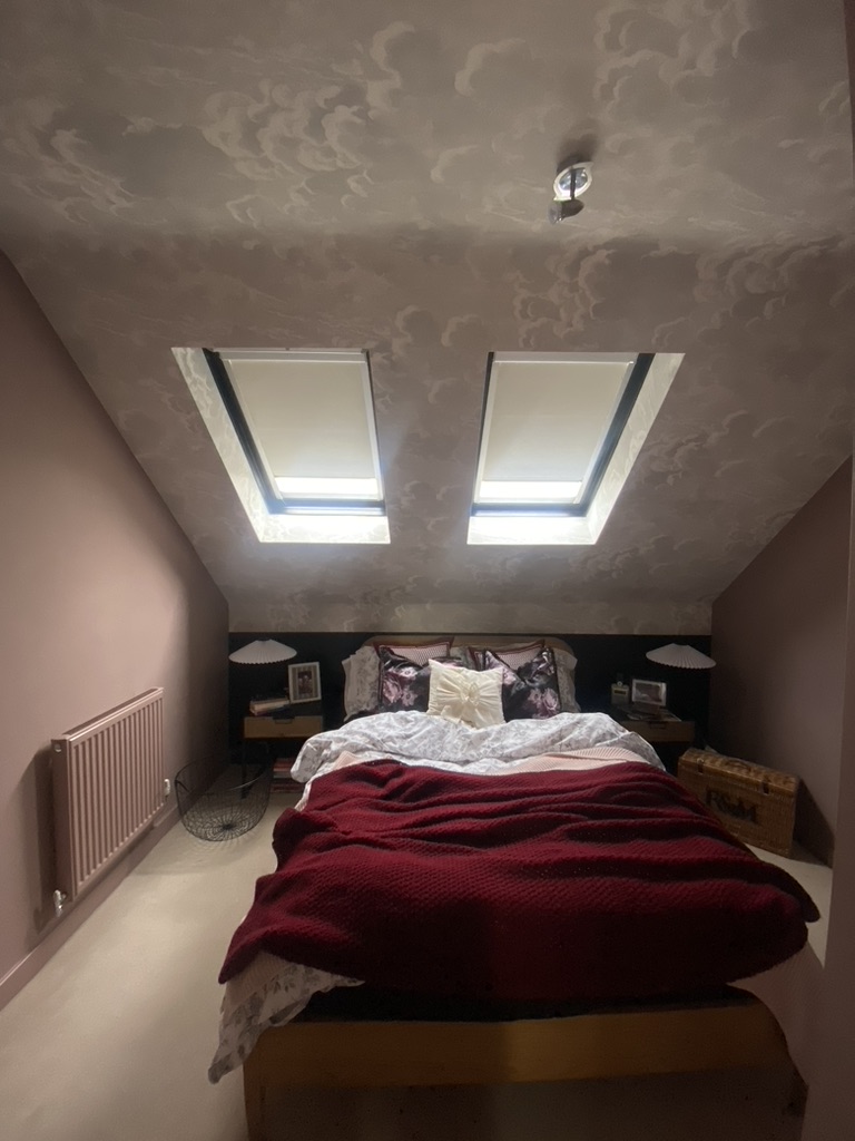 Loft bedroom with a cloud papered ceiling