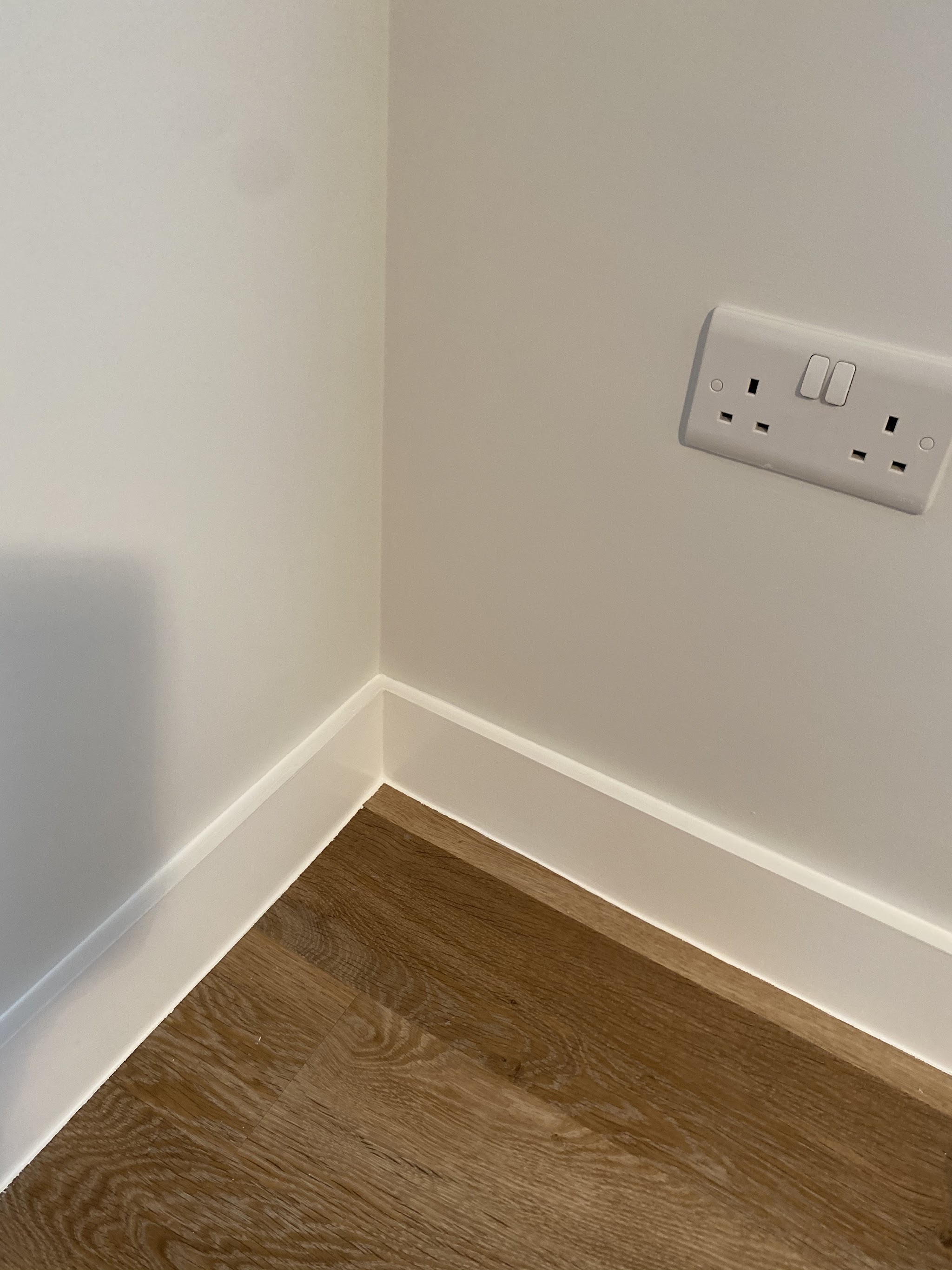 Crisp white skirting and walls meeting a new wooden floor