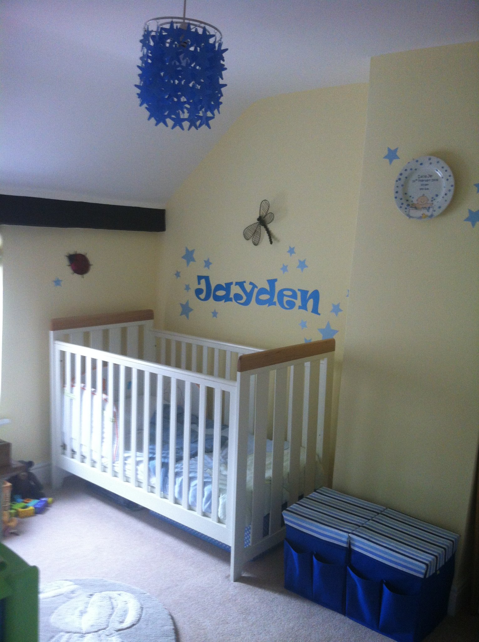 Nursery painted in soft yellow