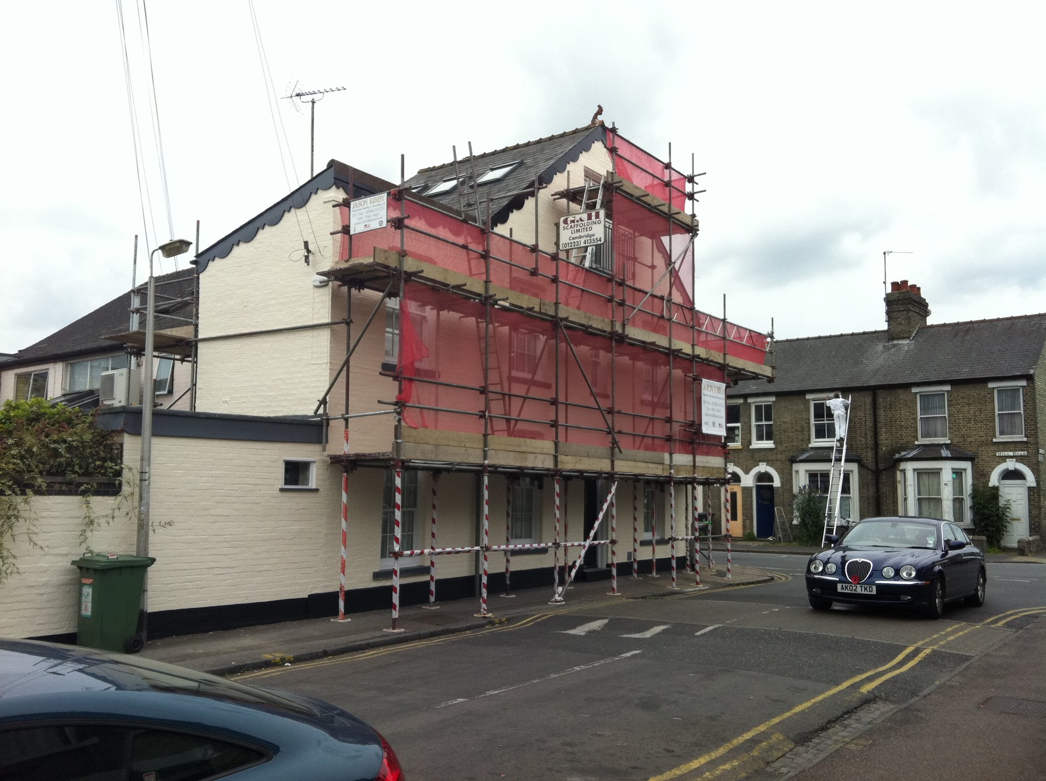 Town house under scaffolding for exterior painting