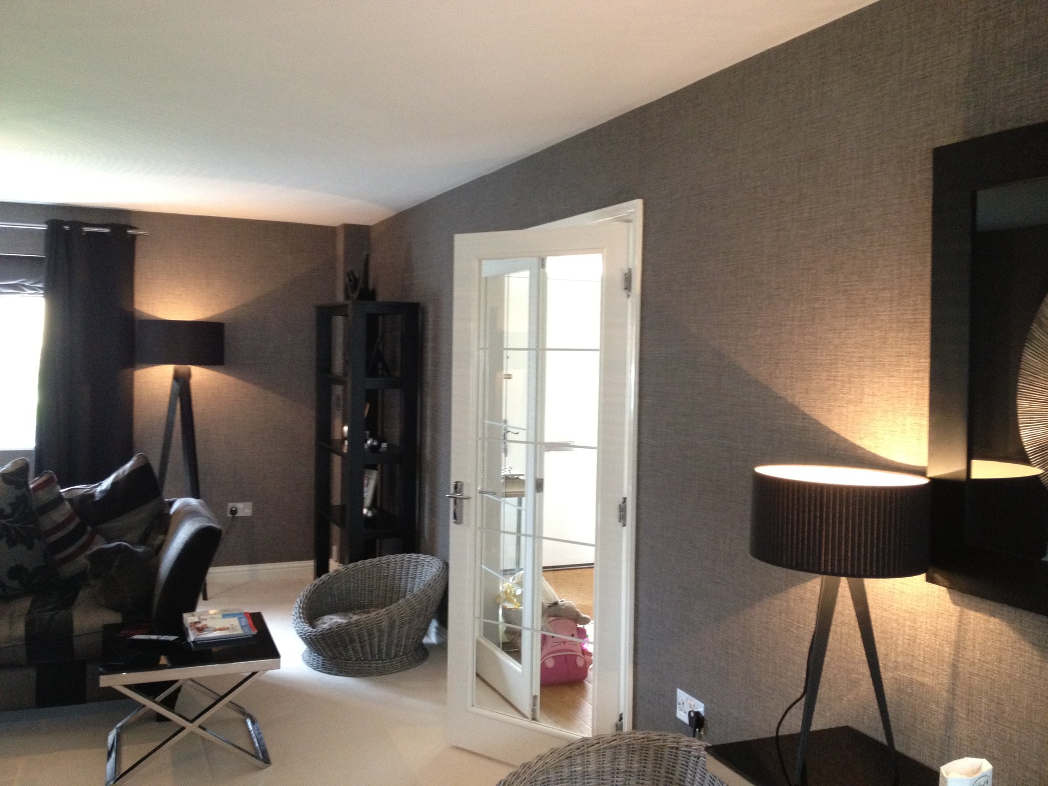 Textured grey wallpaper with lamps and glazed door