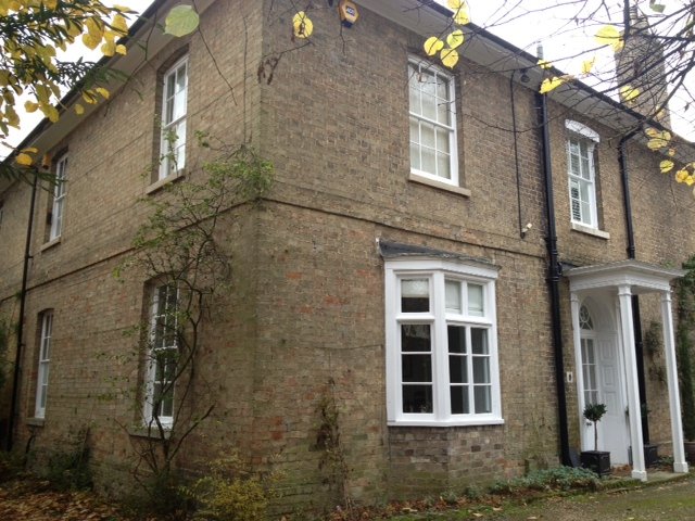 Brick period house with white painted windows and porch