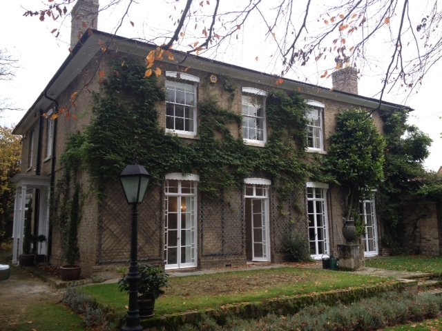 Ivy clad Georgian house with white sash windows