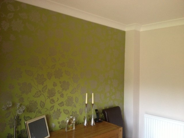 Green damask style wallpaper feature wall