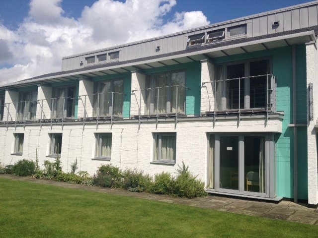 Apartment block with teal and grey painted panels