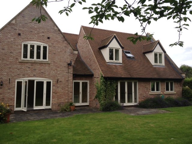 Brick house with cream painted windows and doors