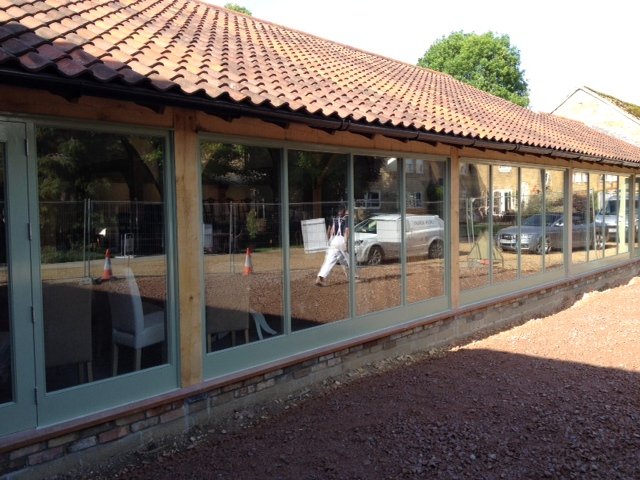 Long glazed oak frame walkway with painted frames