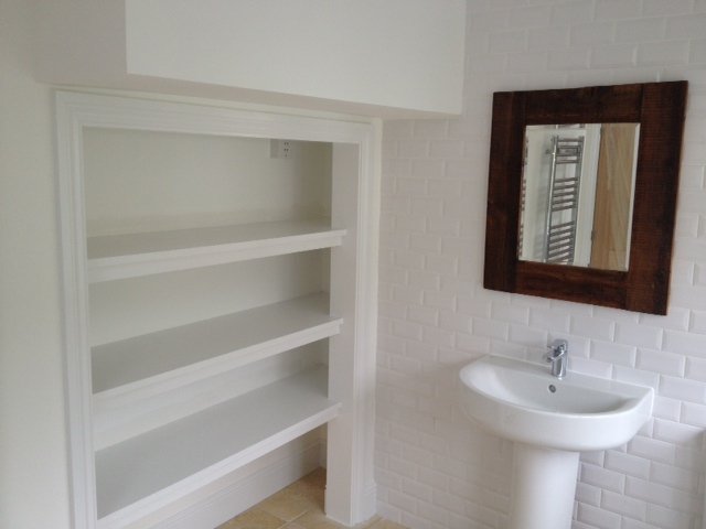 White bathroom with built in shelving