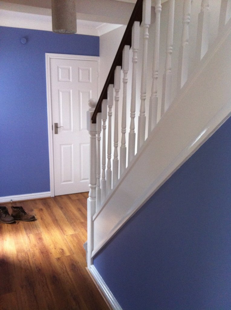 Blue painted hallway with white balustrade